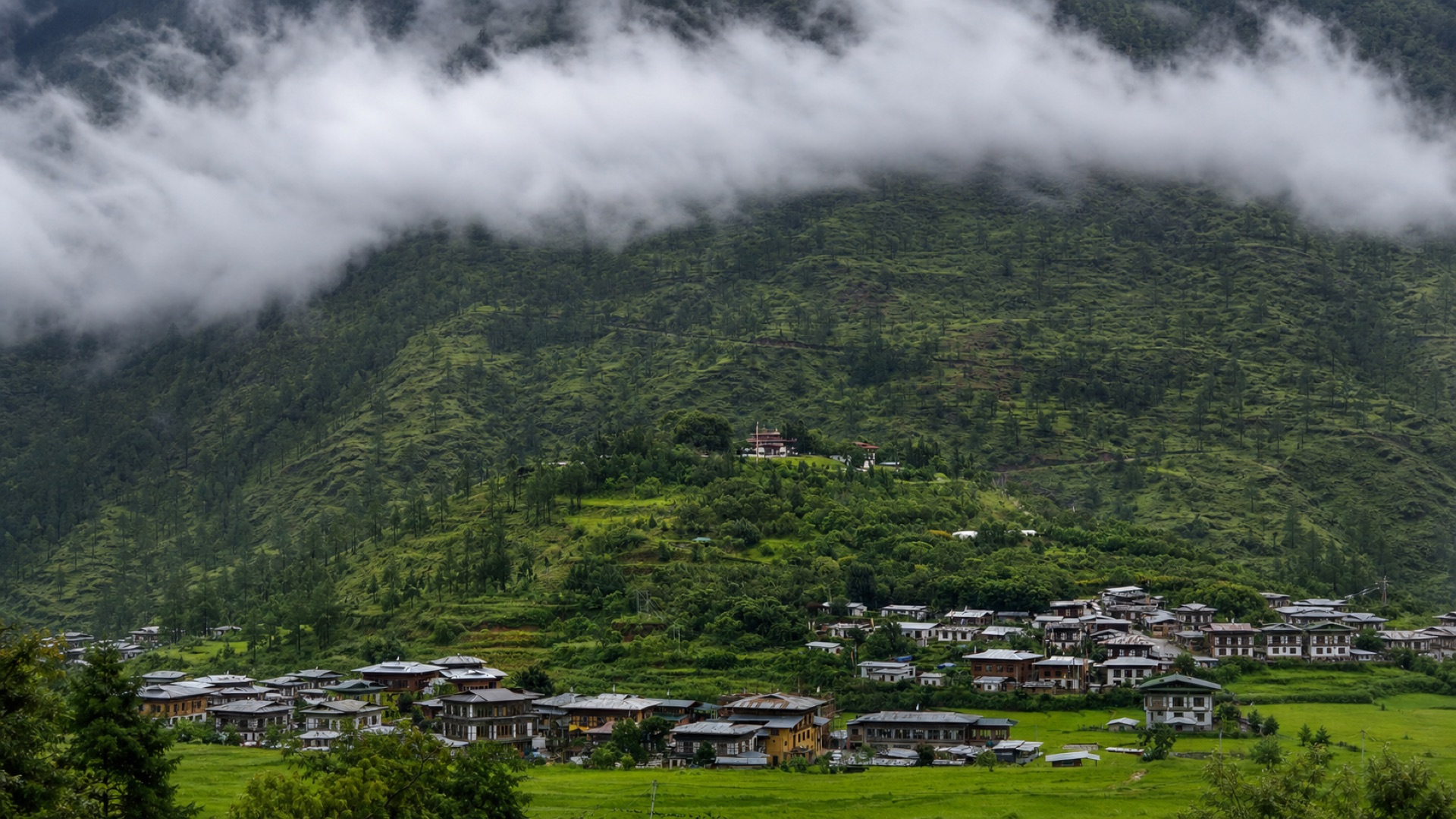 Clouds over a peaceful Bhutanese valley and village